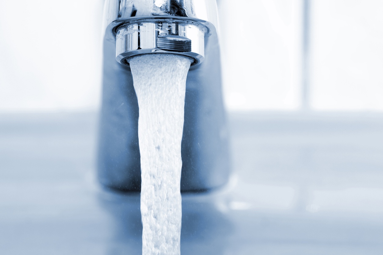 Running faucet, shallow depth of field.