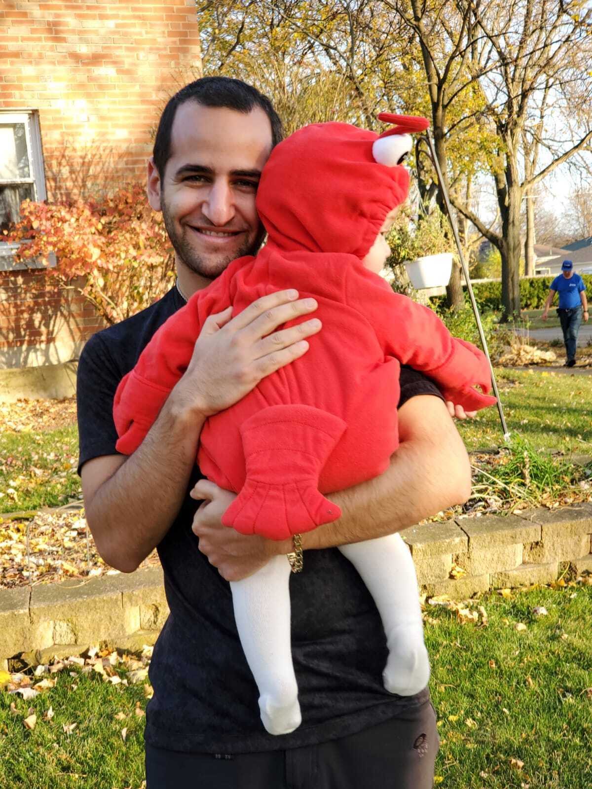 Photo of Charles Dabah holding his son. July 2021.
