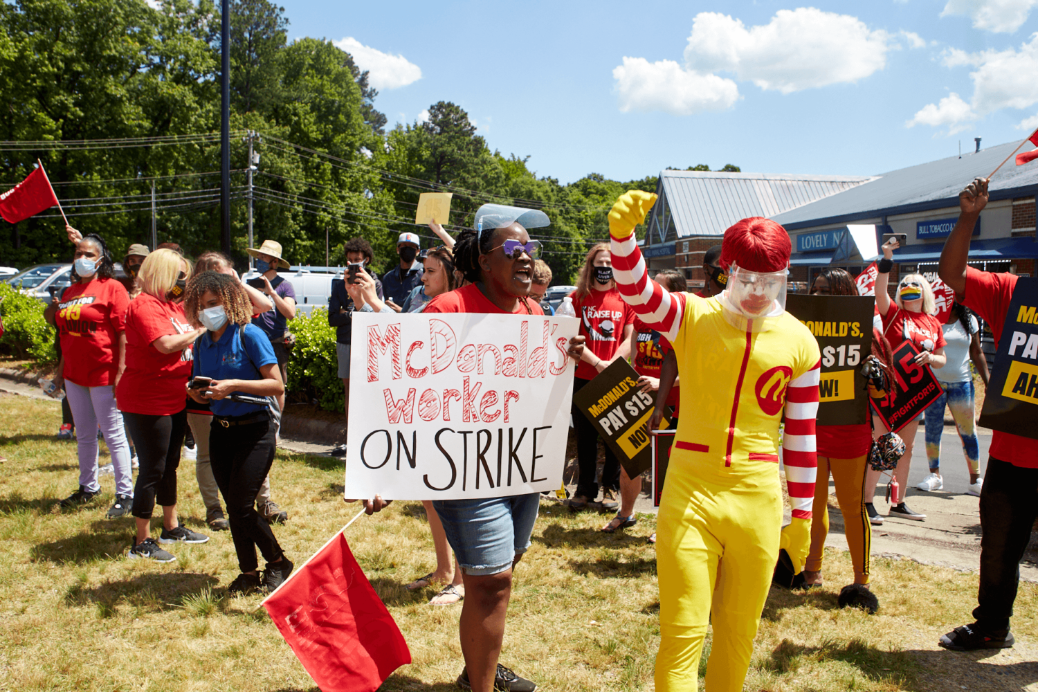 Precious Cole protests next to Ronald McDonald during strike.