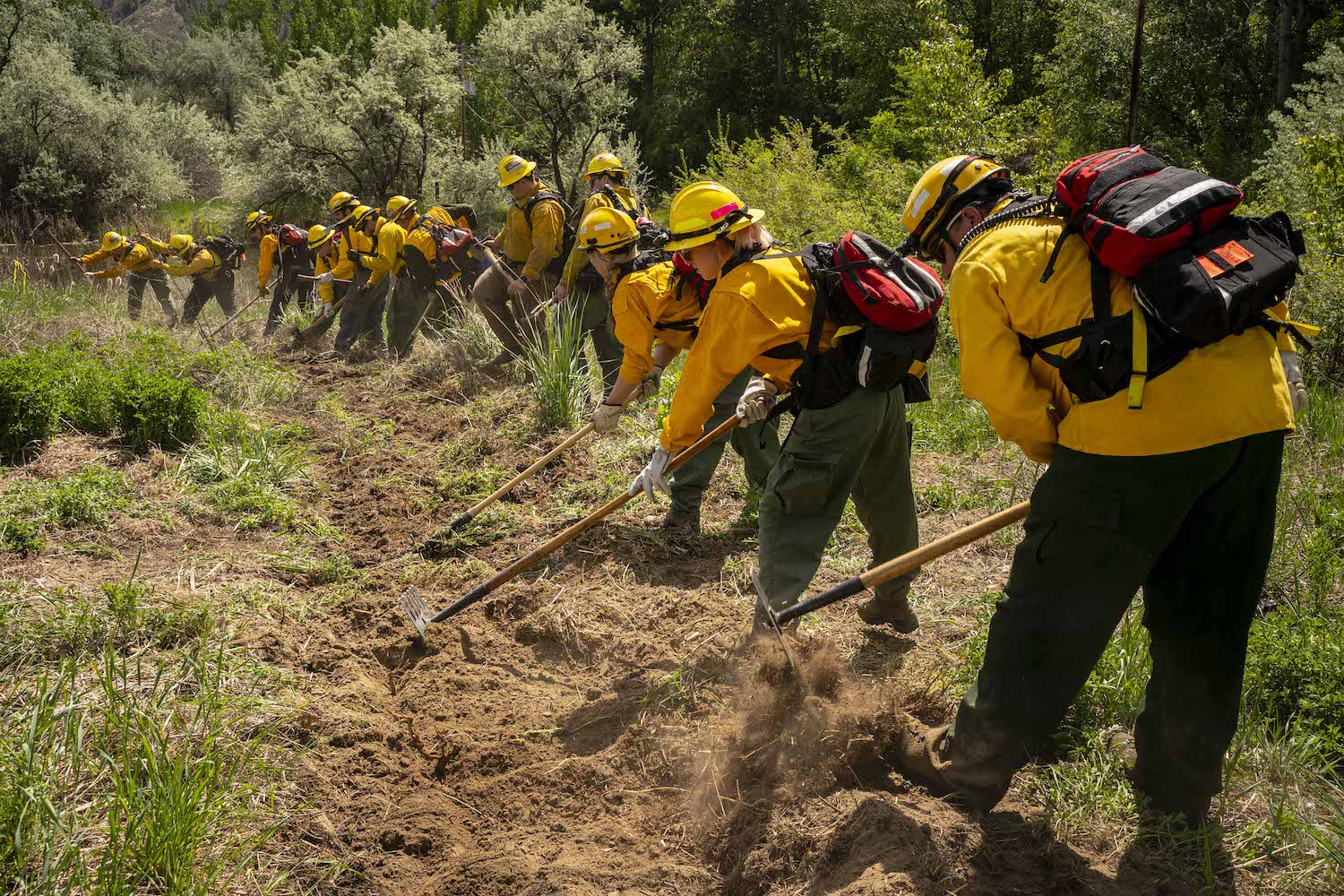 Volunteer firefighters practice with hand tools during a wildfire training course on May 8, 2021 in Brewster, Washington.