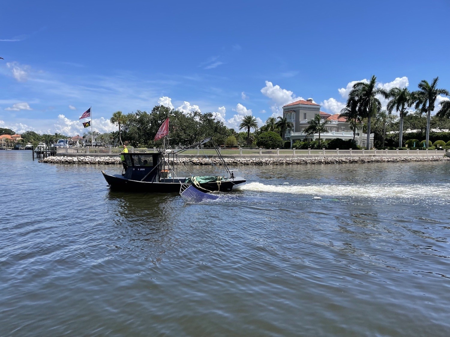 A shrimp trawler pulls along Tampa Bay. July 2021