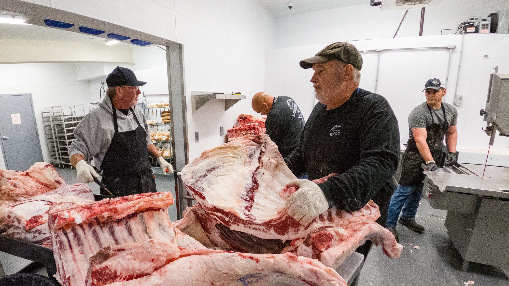 From left, meat cutters Charlie Stedman, Brock Laber, Marty Smith and Zach Sales at Rustic Cuts butcher shop in Council Bluffs, IA, on July 9, 2021.