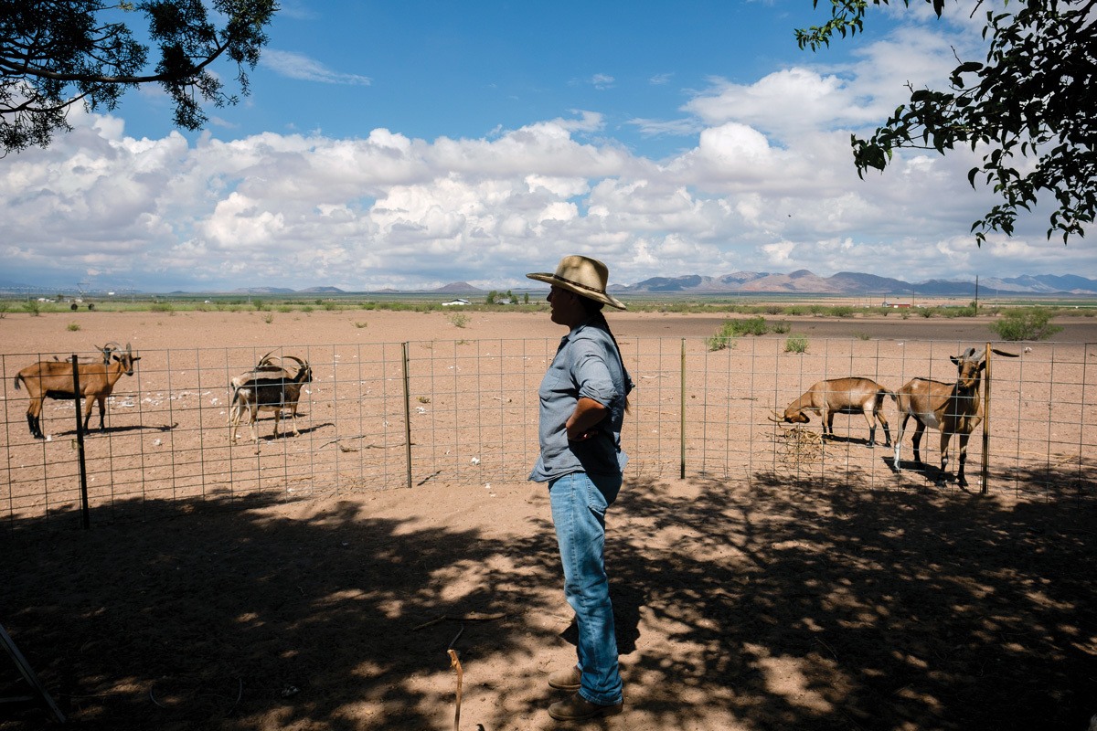 Anastasia Rabin on her small farm in Elfrida, Arizona, where recent dust storms have left deposits of beach-like sand up to two feet deep. August 2021