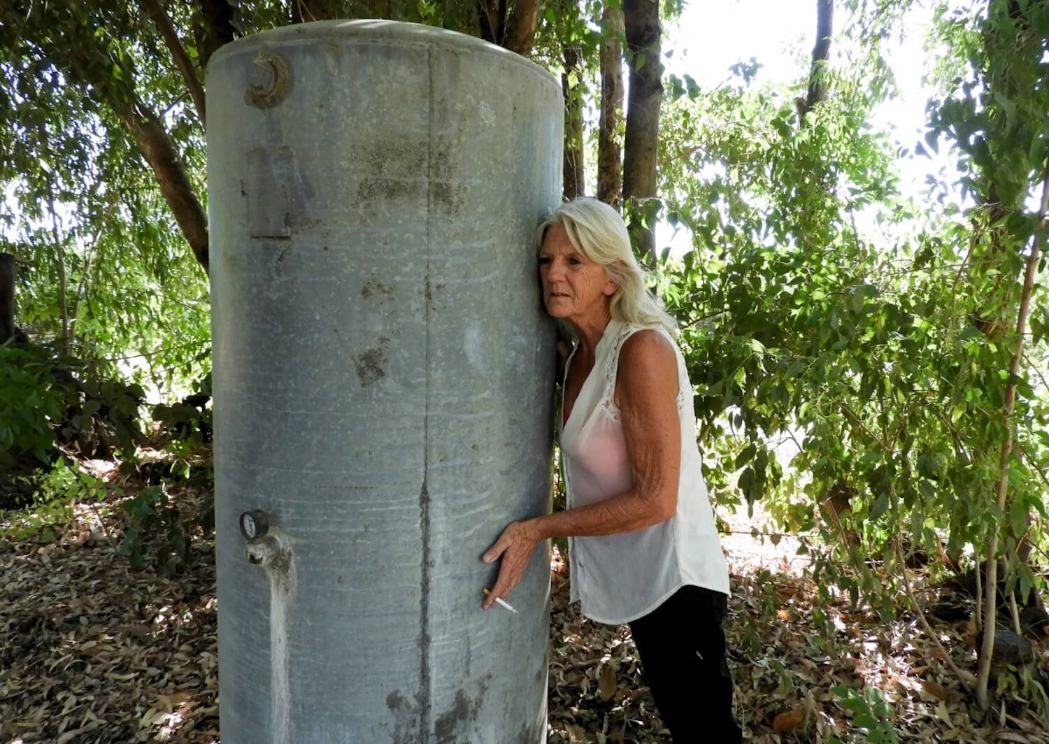 Kelly O’Brien listens to her well hum as it fills with cool water after more than a month of living without water at her home on July 2, 2021. August 2021