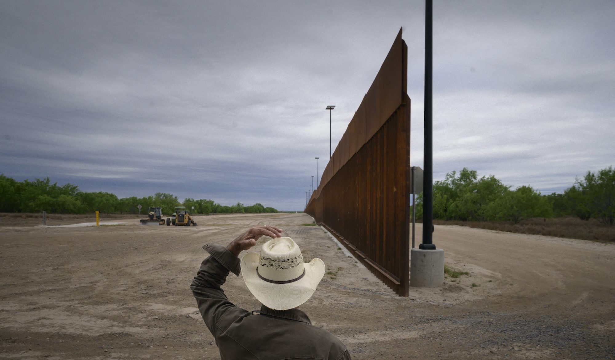 In a photo taken on March 28, 2021 ranch owner Tony Sandoval (67) stands before a portion of the unfinished border wall that former US president Donald Trump tried to build, near the southern Texas border city of Roma. August 2021