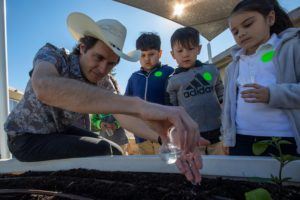 Kimbal Musk, brother of Elon Musk, teaches students at Eucalyptus Elementary School to plant a vegetable garden in preparation for Plant a Seed Day in Hawthorne, California on March 13, 2019.