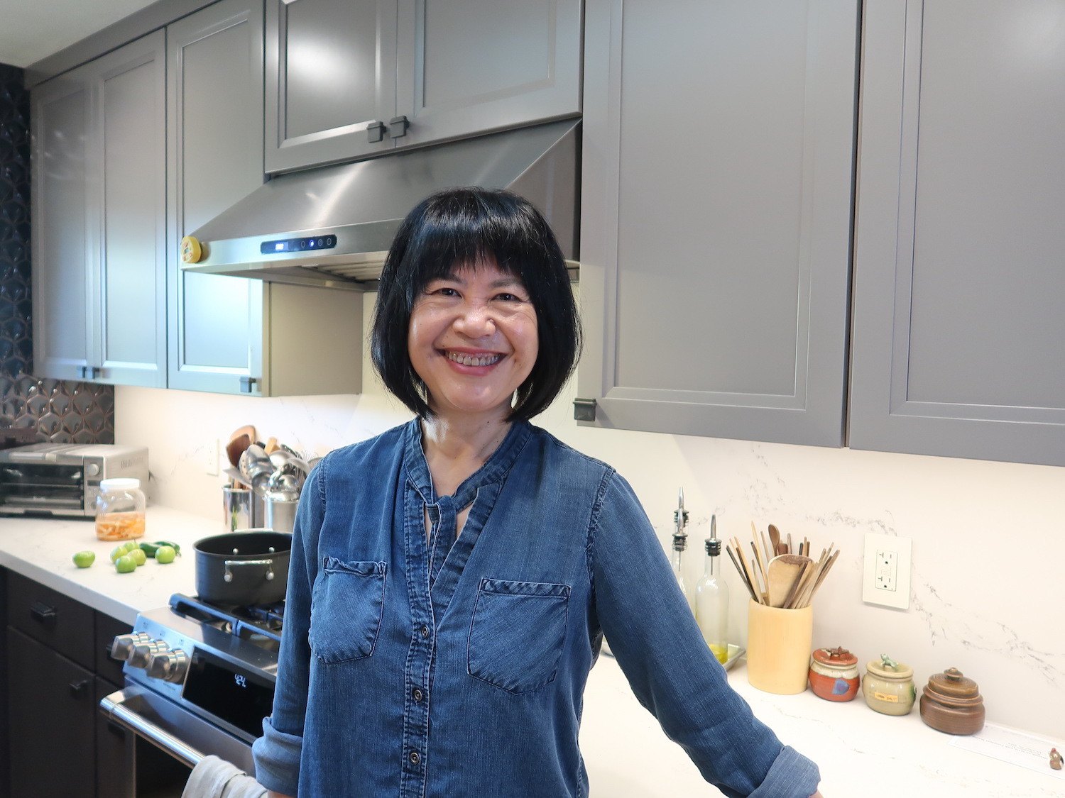 A portrait of cookbook author and chef Andrea Nguyen standing in her kitchen. September 2021