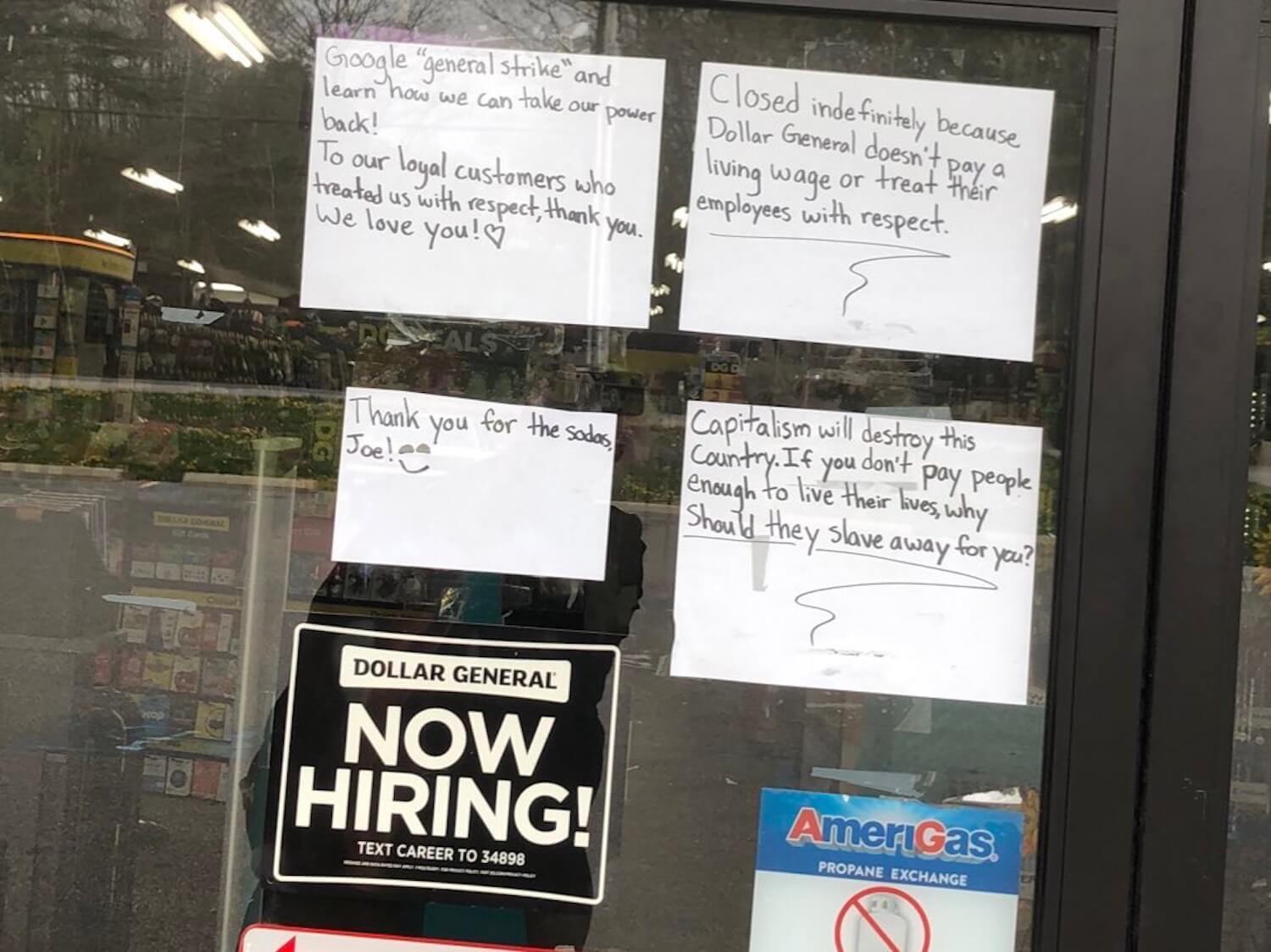 Signs from Dollar General store of employees quitting in protest. September 2021