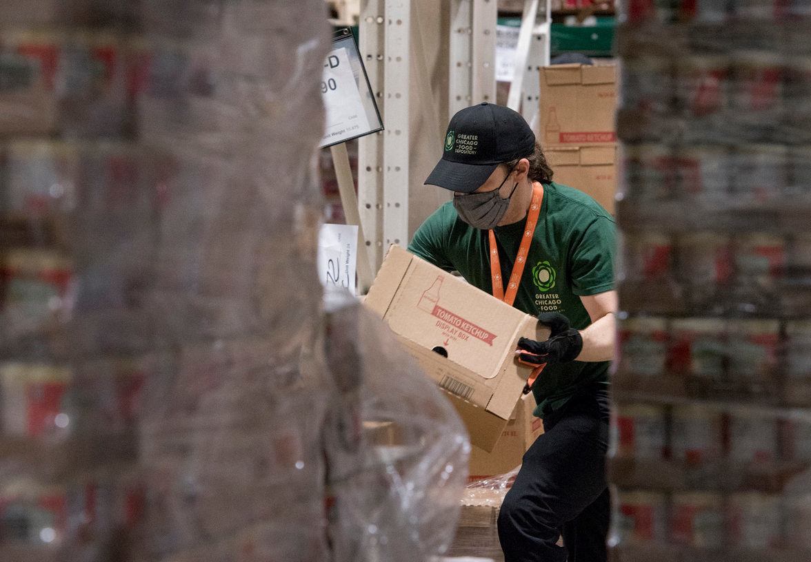 A man carries box at the Greater Chicago Food Depository. October 2021