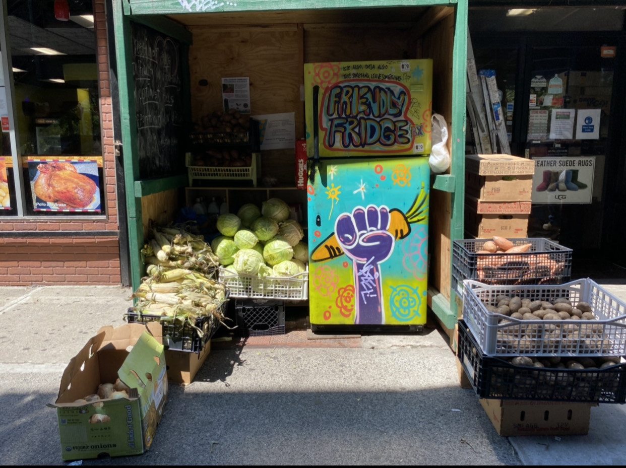 Exterior shot of The Friendly Fridge in the Bronx. Shows produce in stacks outside. October 2021