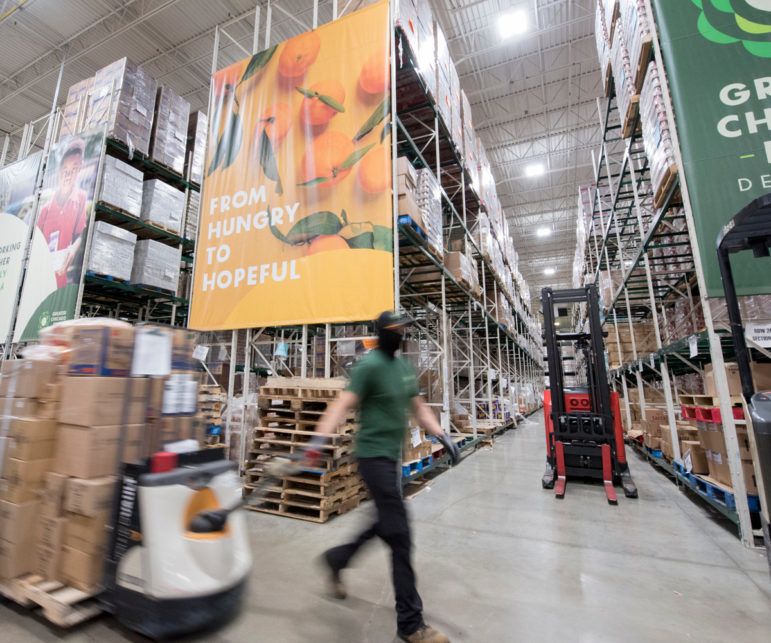 A man moves cart at the greater chicago food depository in chicago 102621