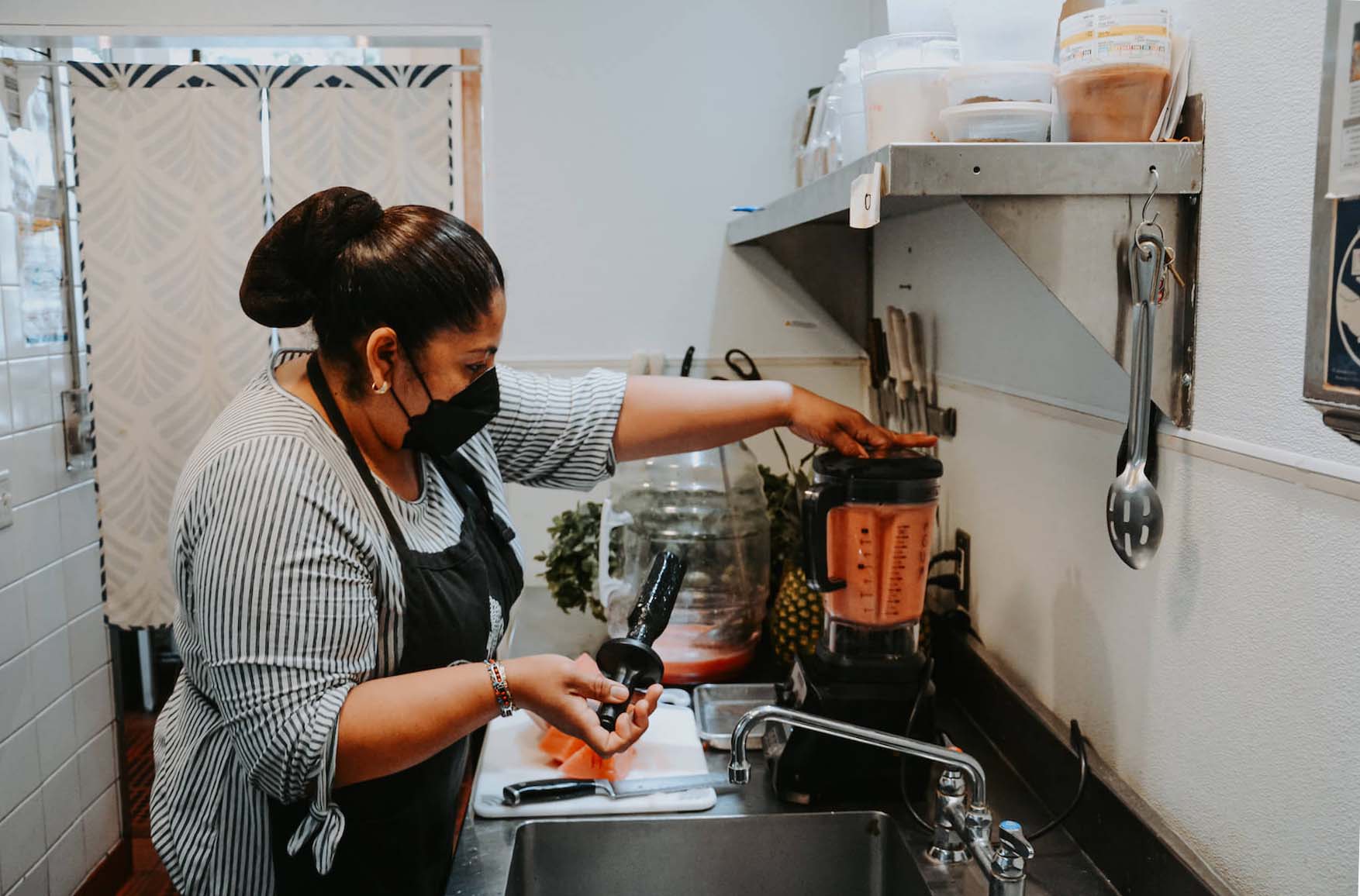 Ofelia Barajas prepares agua de sandia at La Guerrera's Kitchen in Oakland, CA. August 2021