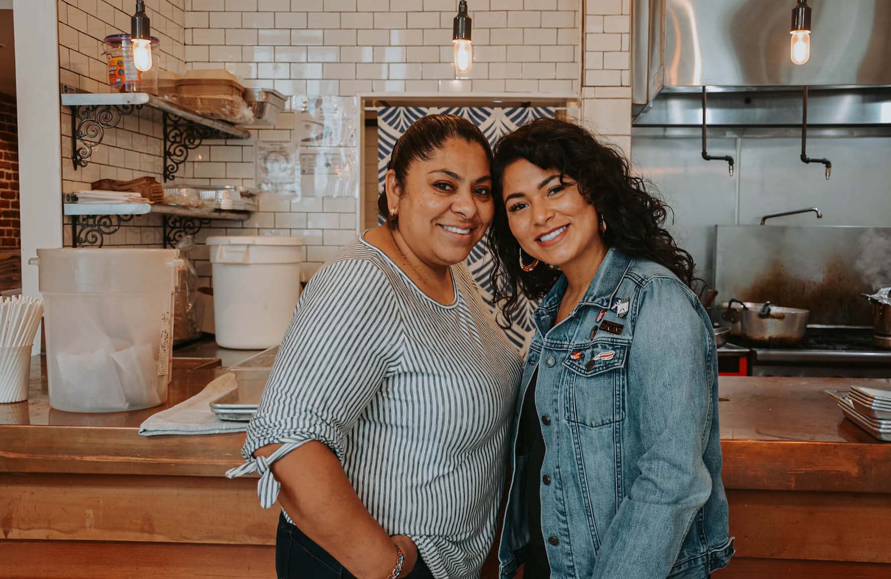 Ofelia Barajas and Reyna Maldonado stand in La Guerrera's Kitchen for a portrait in Oakland, CA. August 2021