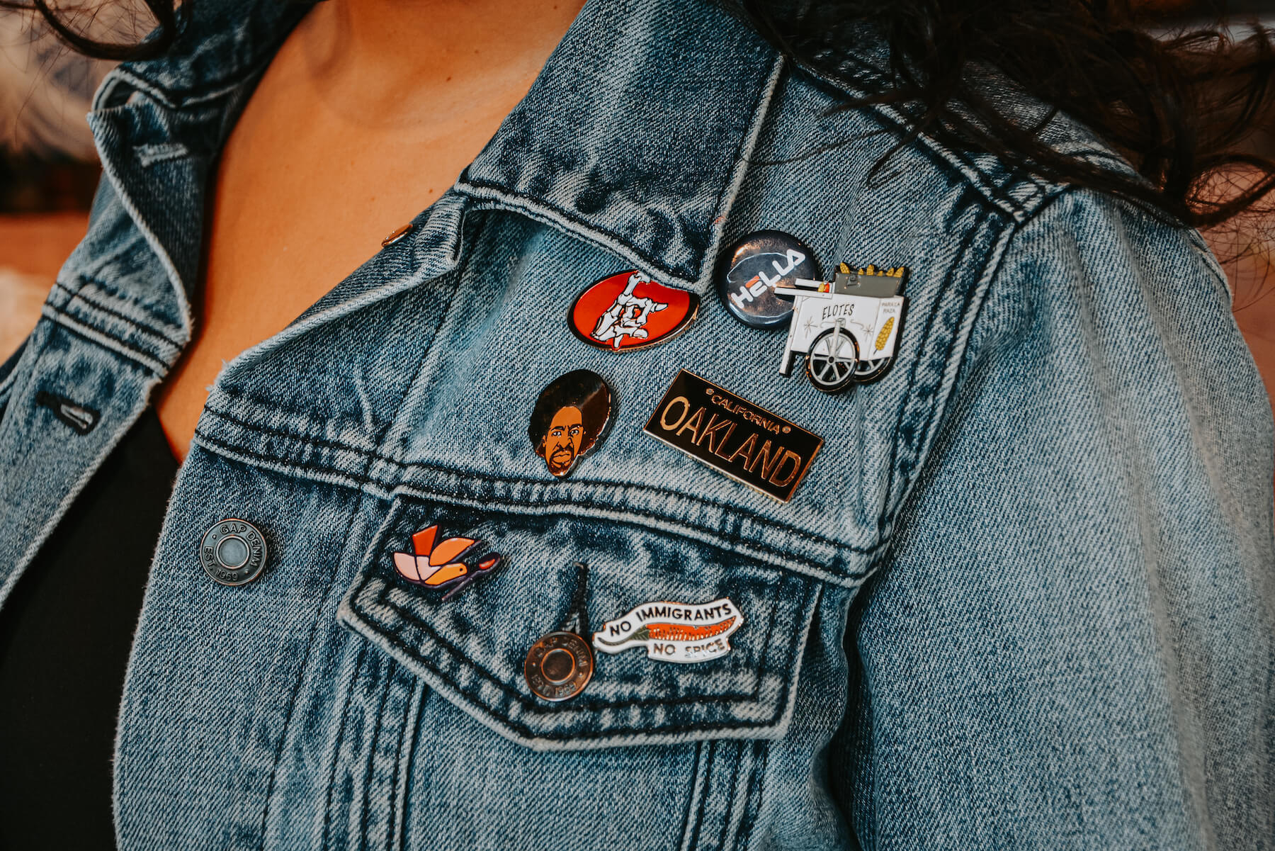 Reyna's assortment of Bay Area and immigrant pins on her denim jacket. August 2021