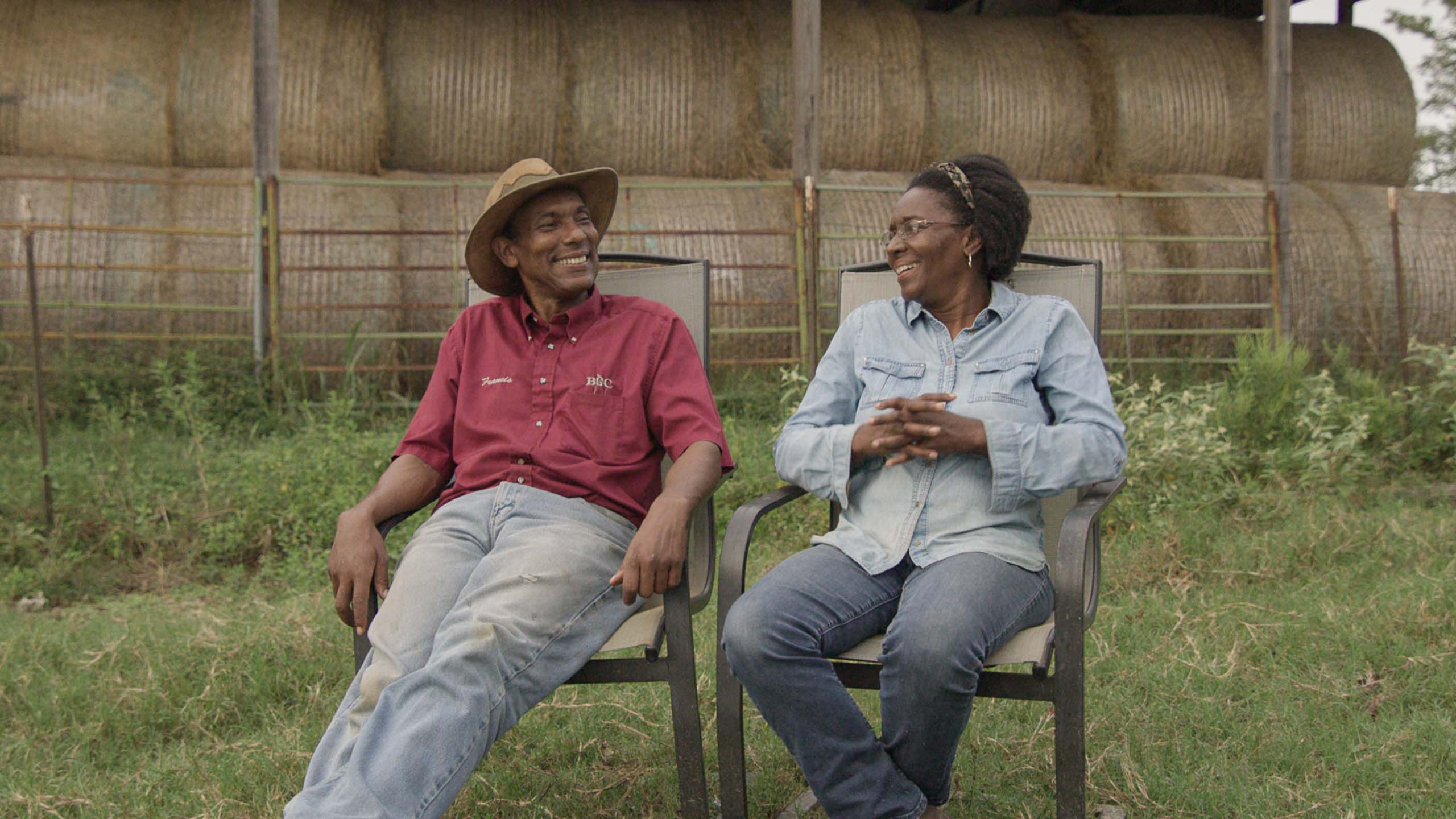 Husband and wife Francis and Cynthia Matlock share a laugh together in front of a haystack on their property. September 2020