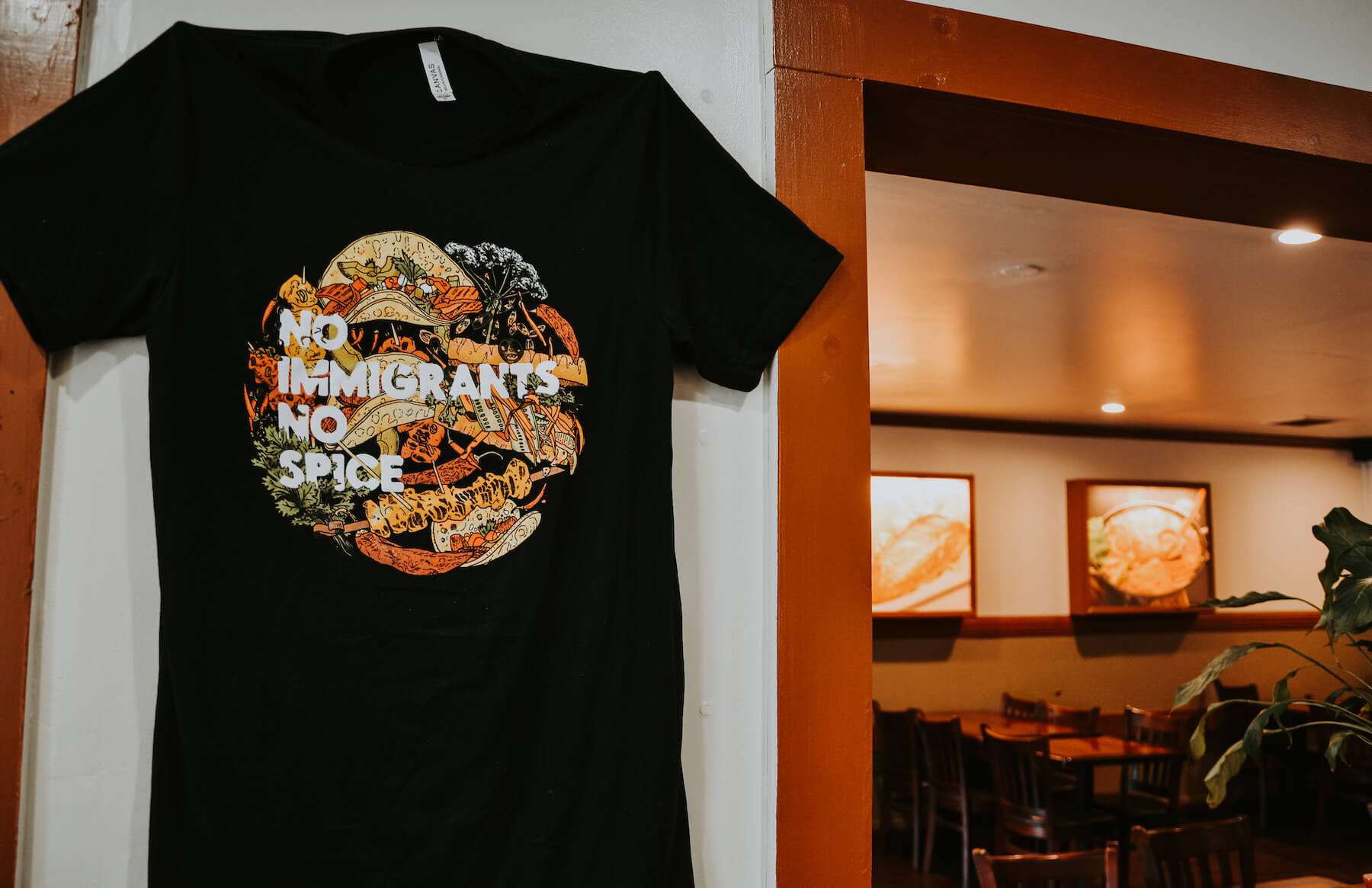 No Immigants No Spice T-shirt inside Daol Tofu in Oakland, CA. August 2021