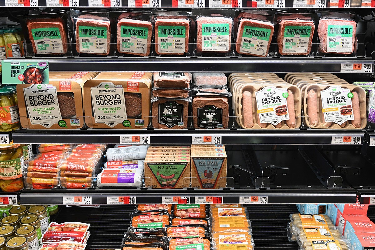 A grocery store shelf with Impossible and Beyond Meat alternative proteins. February 2022