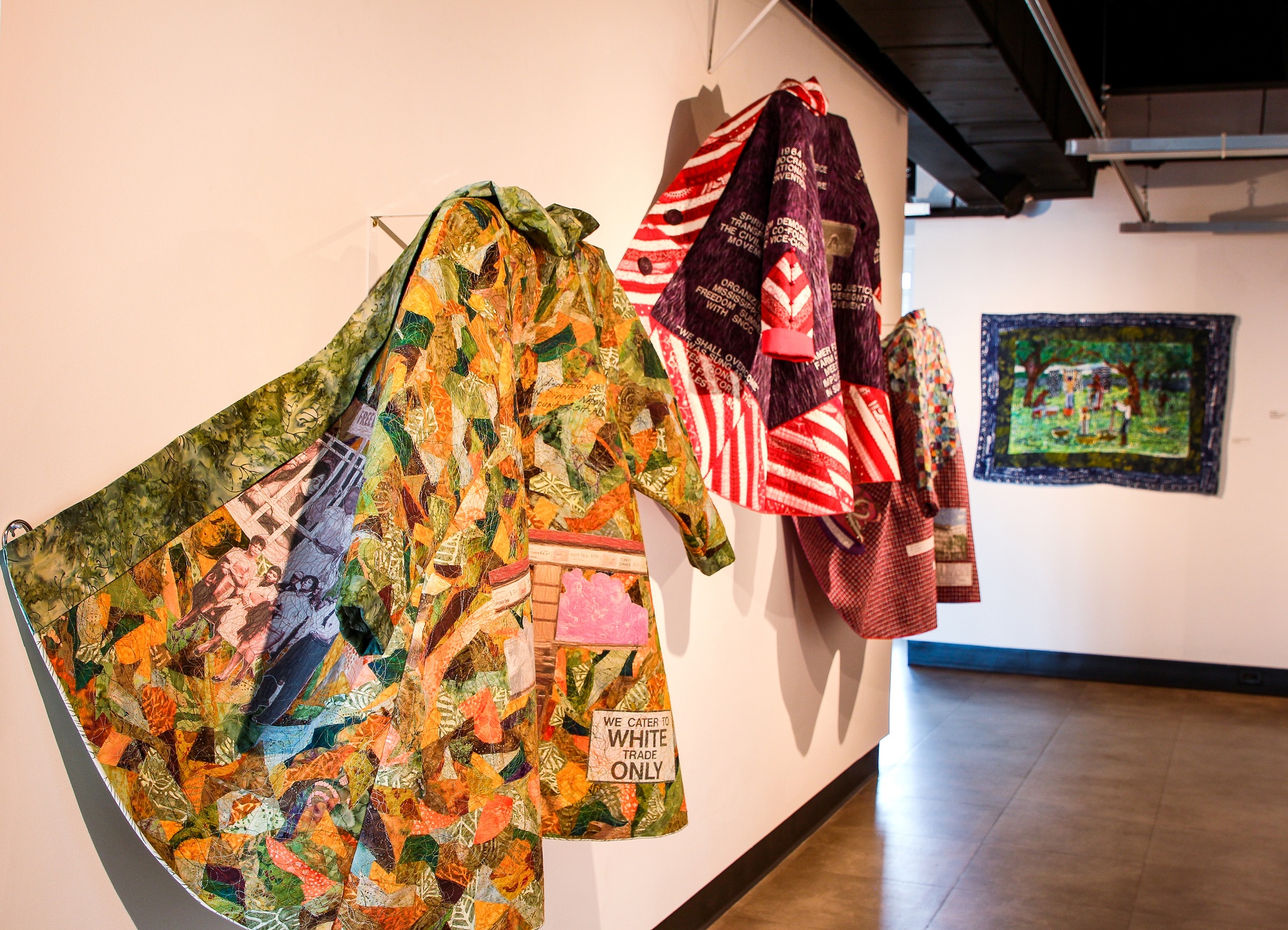 Quilted coats hang in Charleston's City Gallery. Feb. 2022