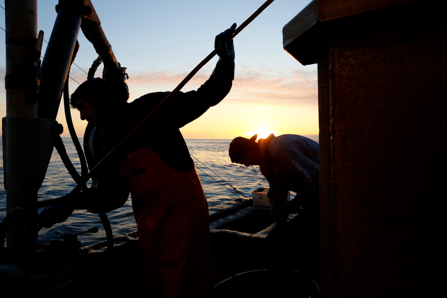 The crew refills bait boxes and shoves crab pots overboard for hours, day and night. March 2022