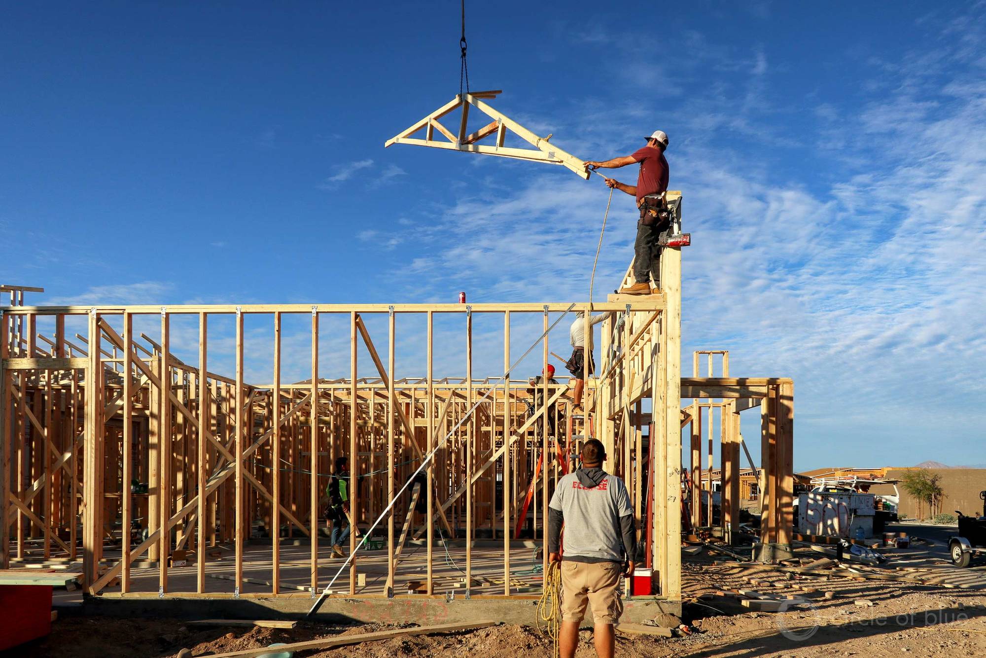 A house is constructed in Pinal County, Arizona with construction crew surrounding March 2022.