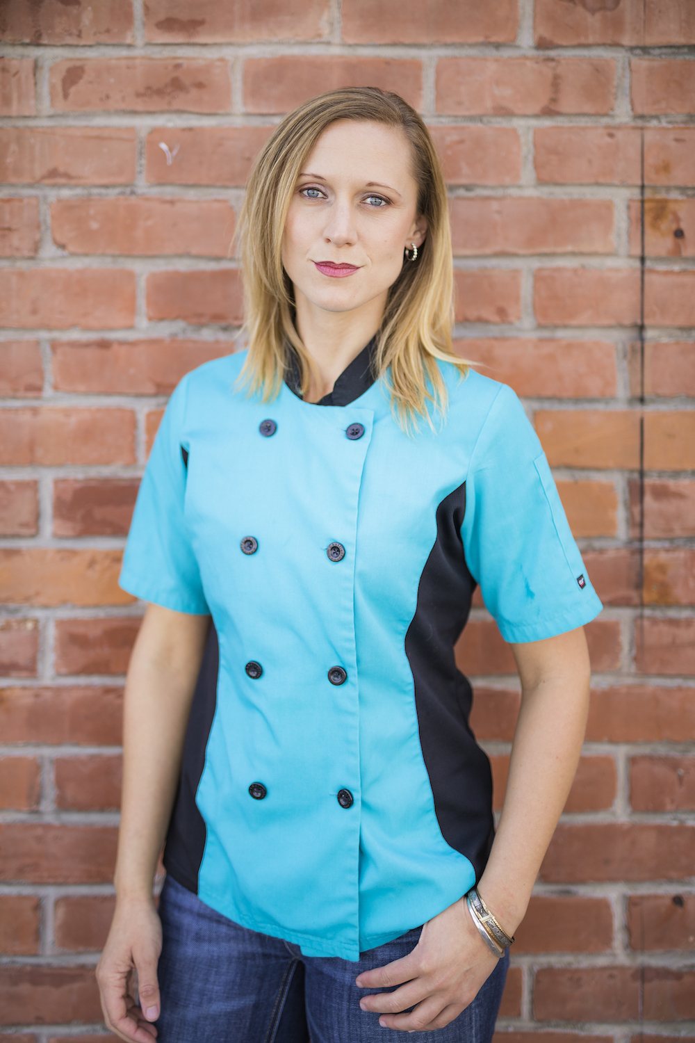 Eliza Martin portrait in a blue chef coat. April 2022