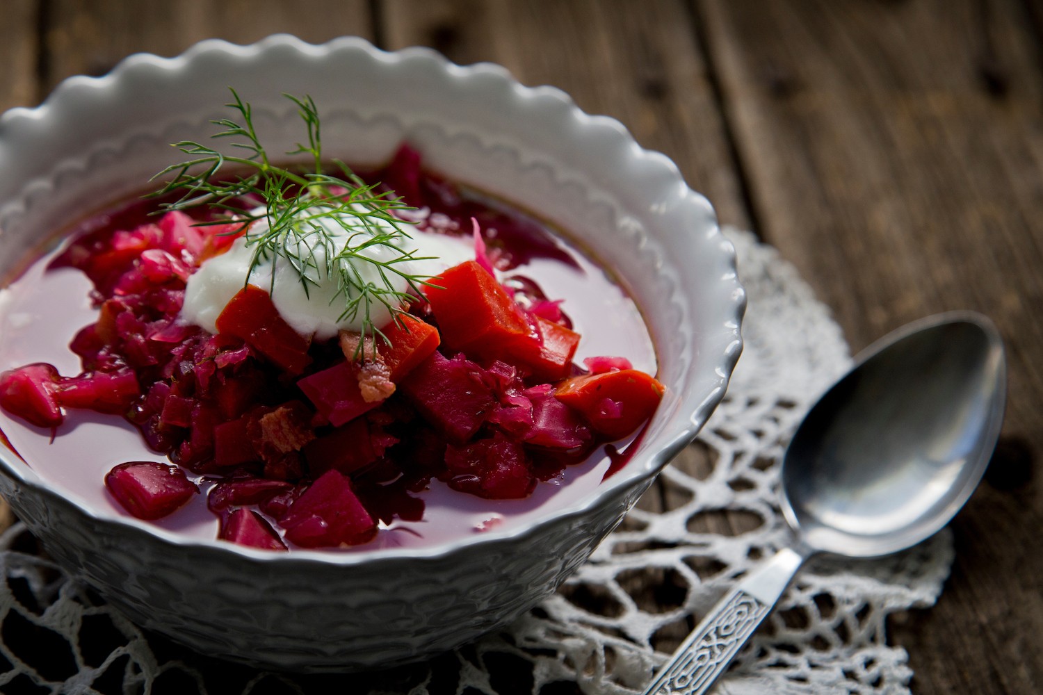 Close up of borscht served on table with a spoon. May 2022