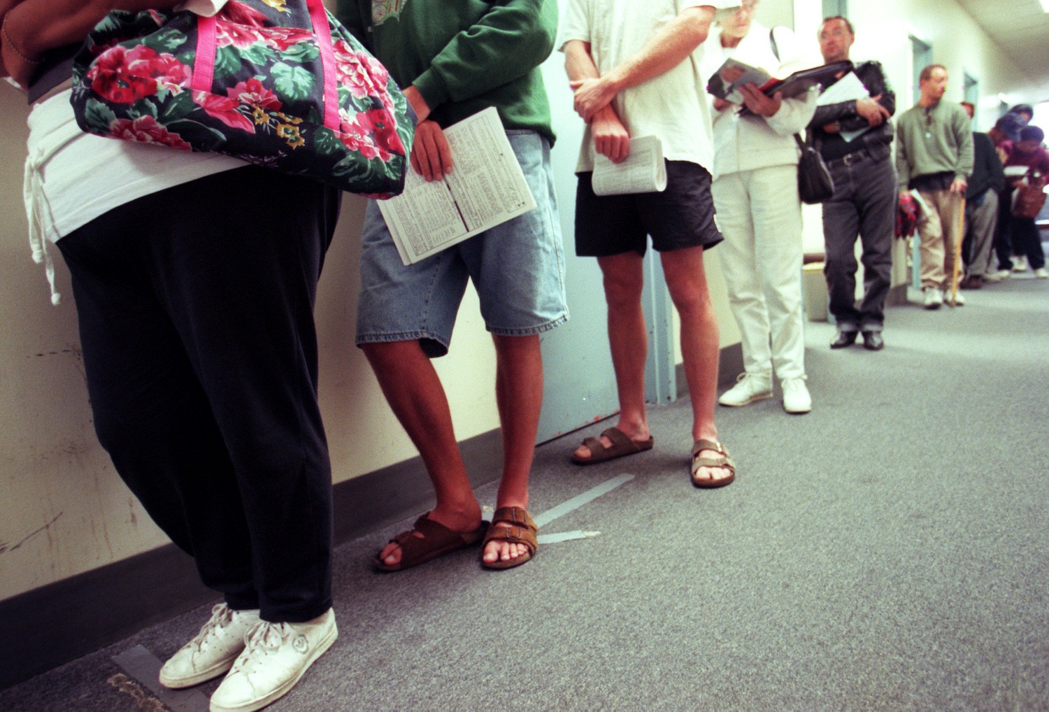 Applicants for food stamps line up in the hallway while they wait for their appointments with a counselor at the Dept of Social Services in Santa Ana. The rules for obtaining food stamps has changed with new restrictions on legal immigrants and the working poor.